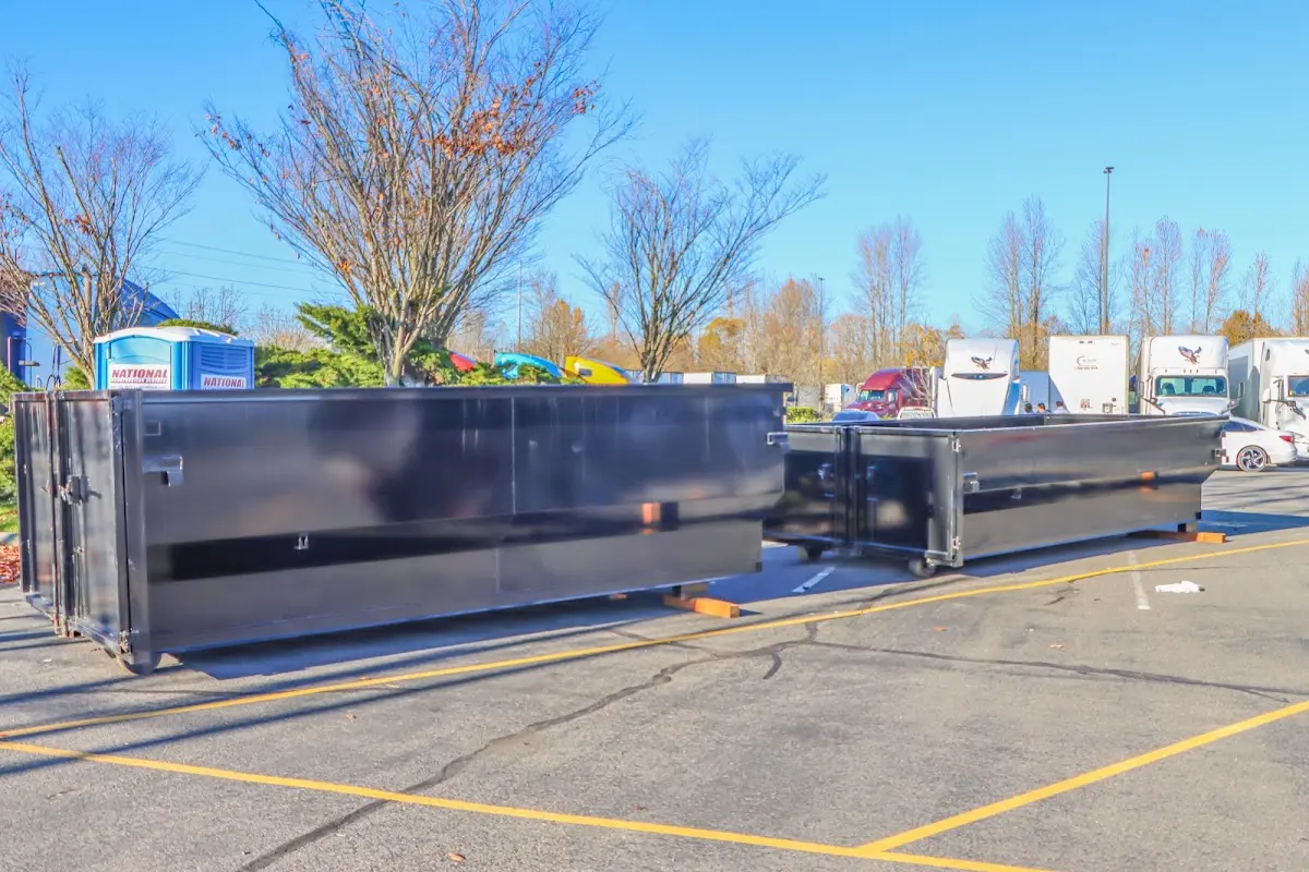 Professional dumpster rental service with roll-off container on residential driveway in Mount Dora